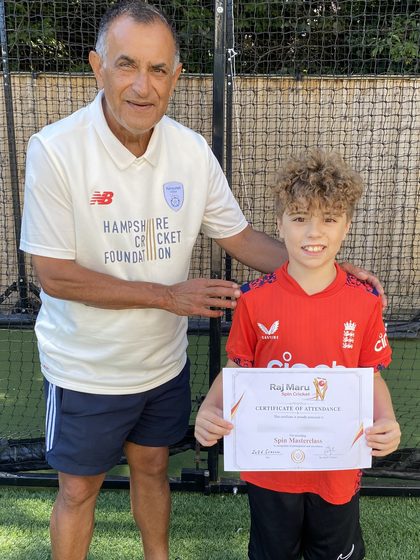 Raj Maru standing with Ollie in the nets, Ollie holding
                      his Spin Masterclass certificate